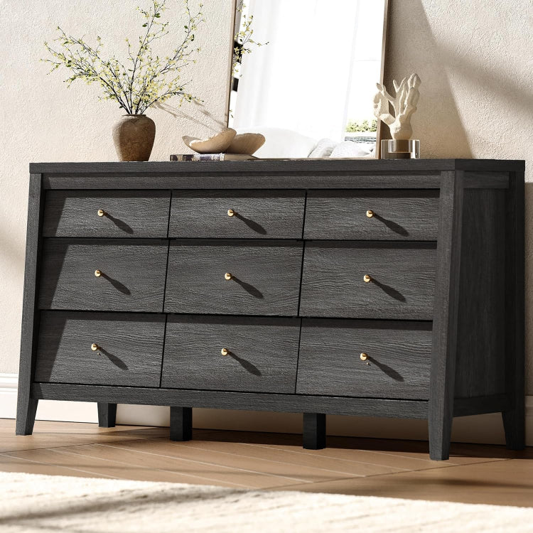 Dark wood dresser with gold knobs in a room setting